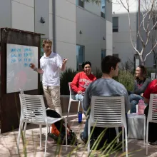 Students writing on the white board