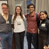 Franke Honors students standing in front of a poster at a conference. 